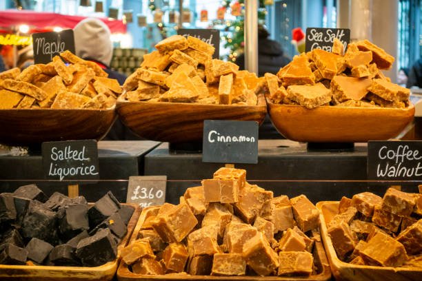 Different flavours of fudge displayed on a fudge stall in Borough Market, Southwark, London. Amongst those shown are maple, sea salt caramel, salted liquorice, cinnamon and coffee walnut.