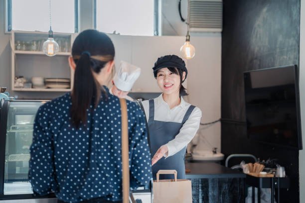 Young woman getting takeout at a specialty store